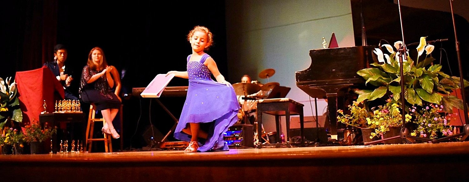 A student taking a bow on stage
