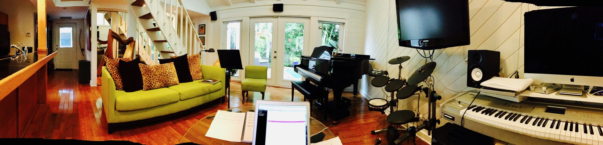 The Music Room studio with a piano, drum kit and harp