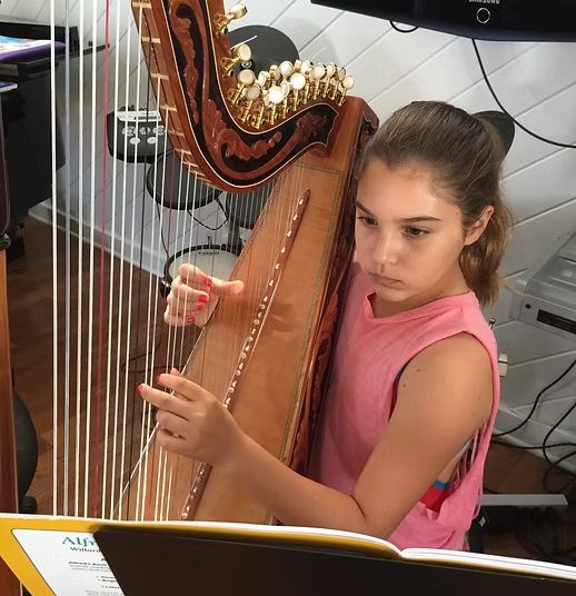 A student playing the harp